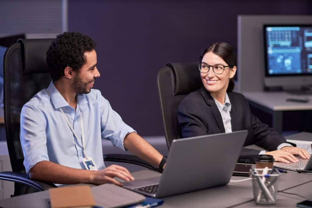 Two smiling business people discussing project in meeting